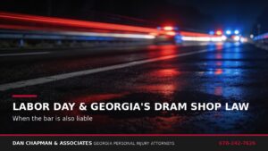 Wet Georgia highway at night reflecting distant emergency lights