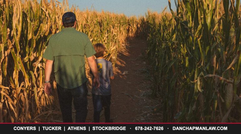 Father and son walking through a Georgia corn maze in the fall